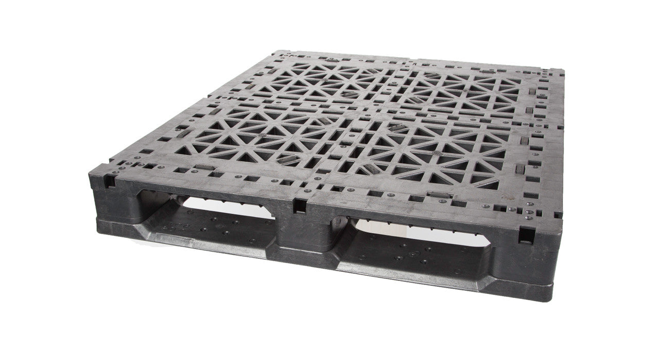 A black plastic pallet with a grid-patterned top surface and built-in handles, designed for transporting and storing goods, is shown on a white background.