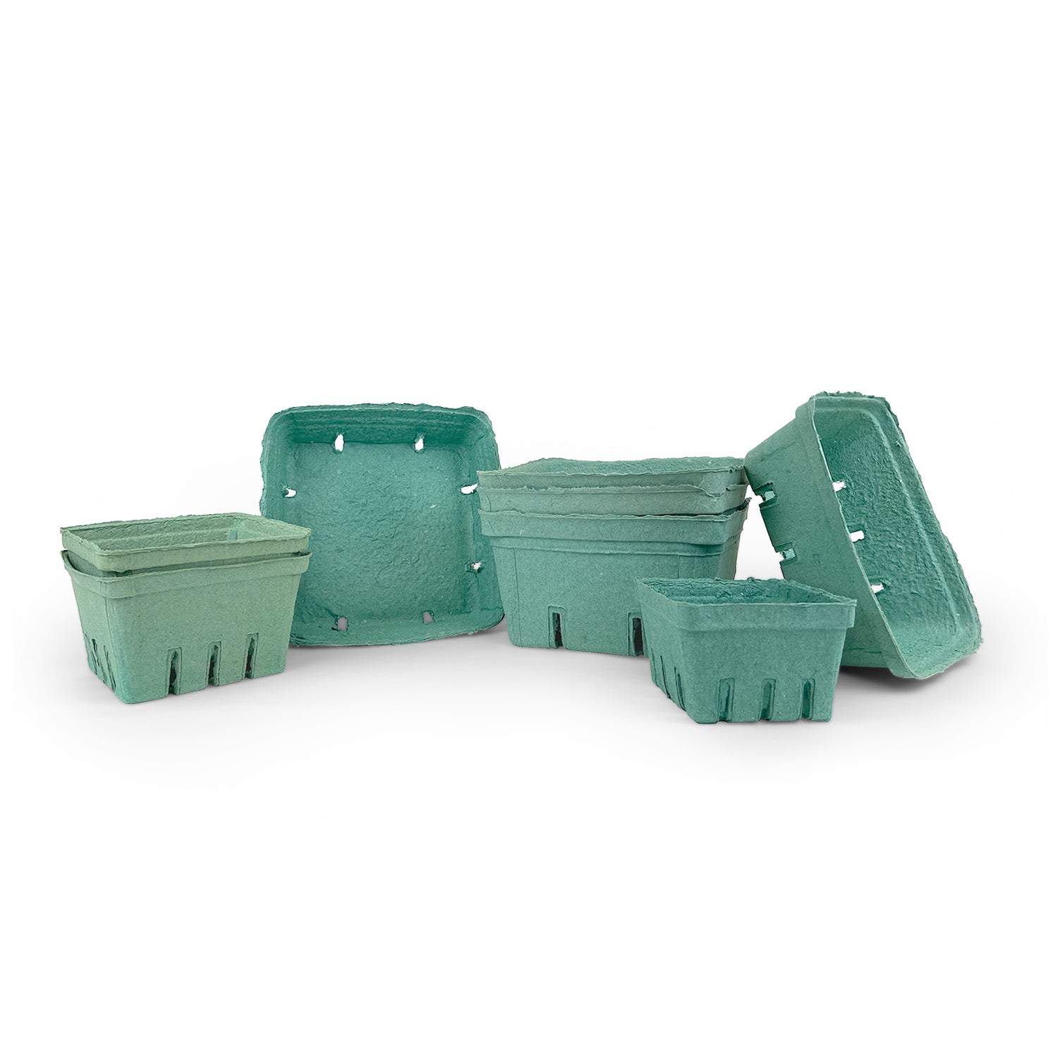 A group of empty, green, square paper pulp berry baskets are arranged on a white background, with some stacked and some lying on their sides.