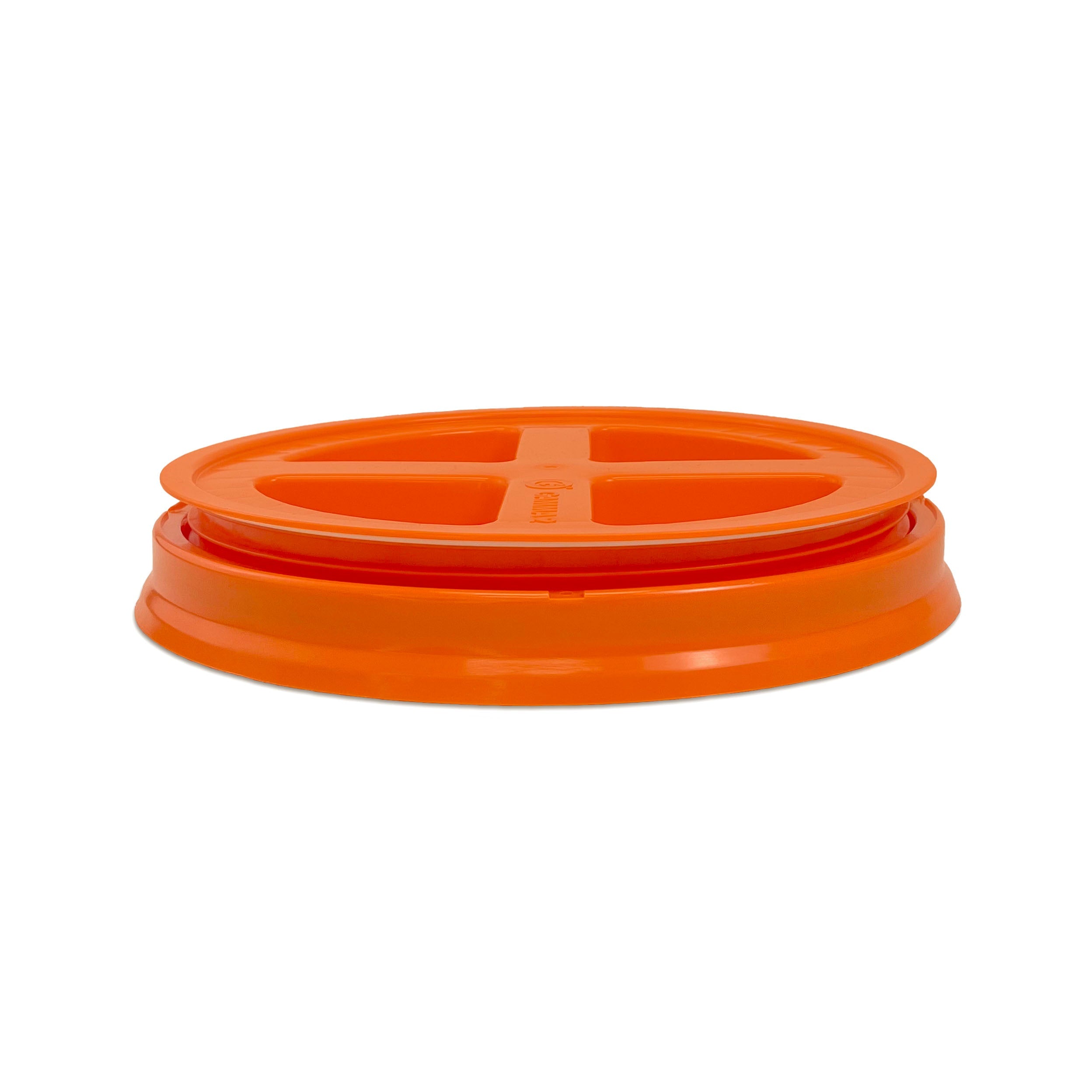 A BPA-free food-grade Gamma Seal Lid for 3.5, 5, and 7 gallon buckets, featuring an orange round design with four cross-shaped openings, ideal for sealing containers; shown against a white background.