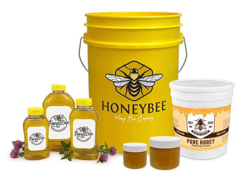Assorted honey products, including a large yellow bucket labeled HONEYBEE, a white tub labeled PURE HONEY, three small bottles, two jars, and clover flowers, all with bee-themed branding.
