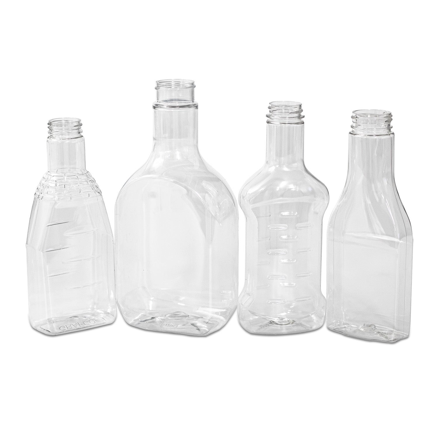 Four empty, clear plastic bottles of different shapes and sizes are standing upright in a row against a white background.