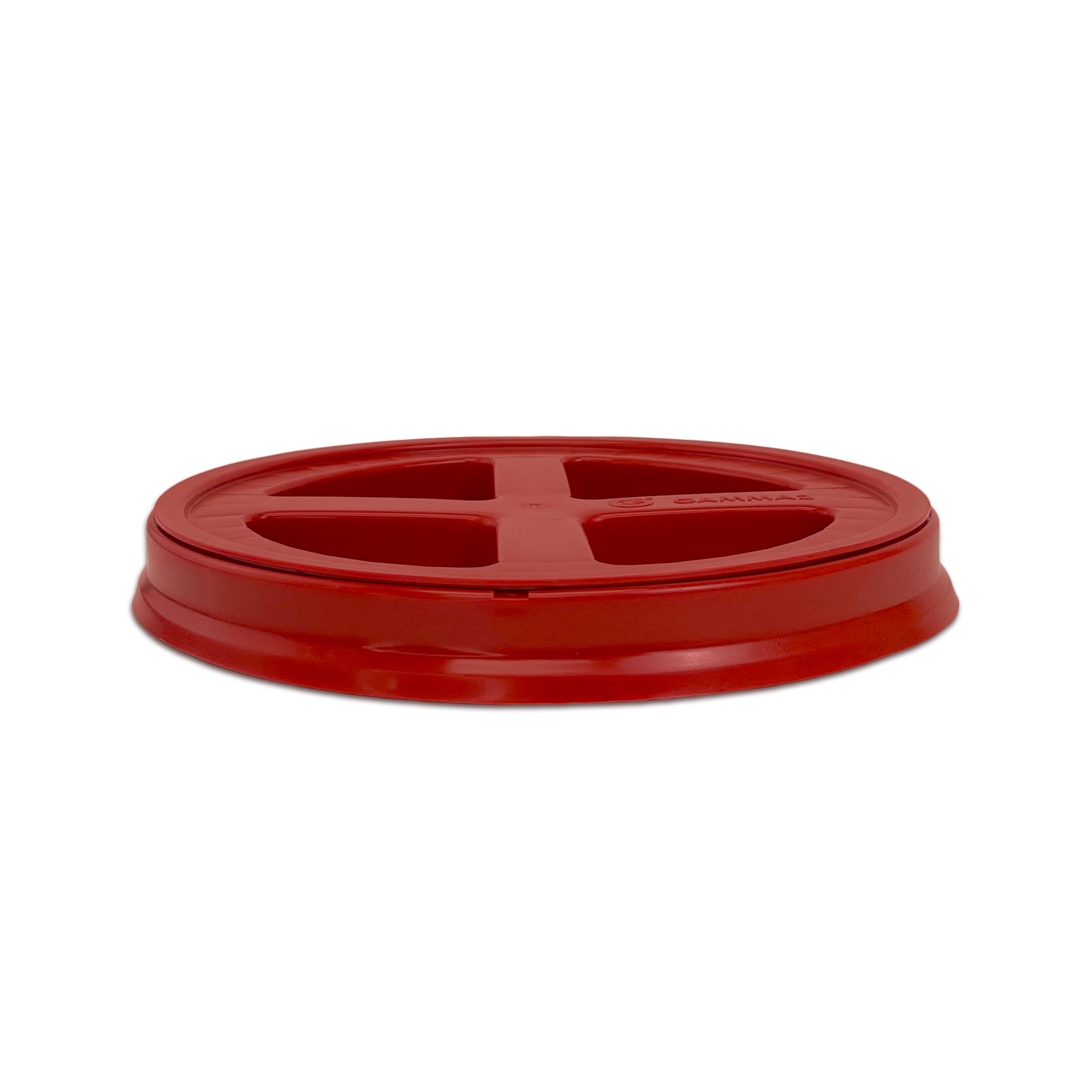 A BPA-free, food-grade Gamma Seal Lid for 3.5, 5, and 7 gallon buckets is shown from the side; its red plastic design features four triangular openings in a cross pattern against a white background.
