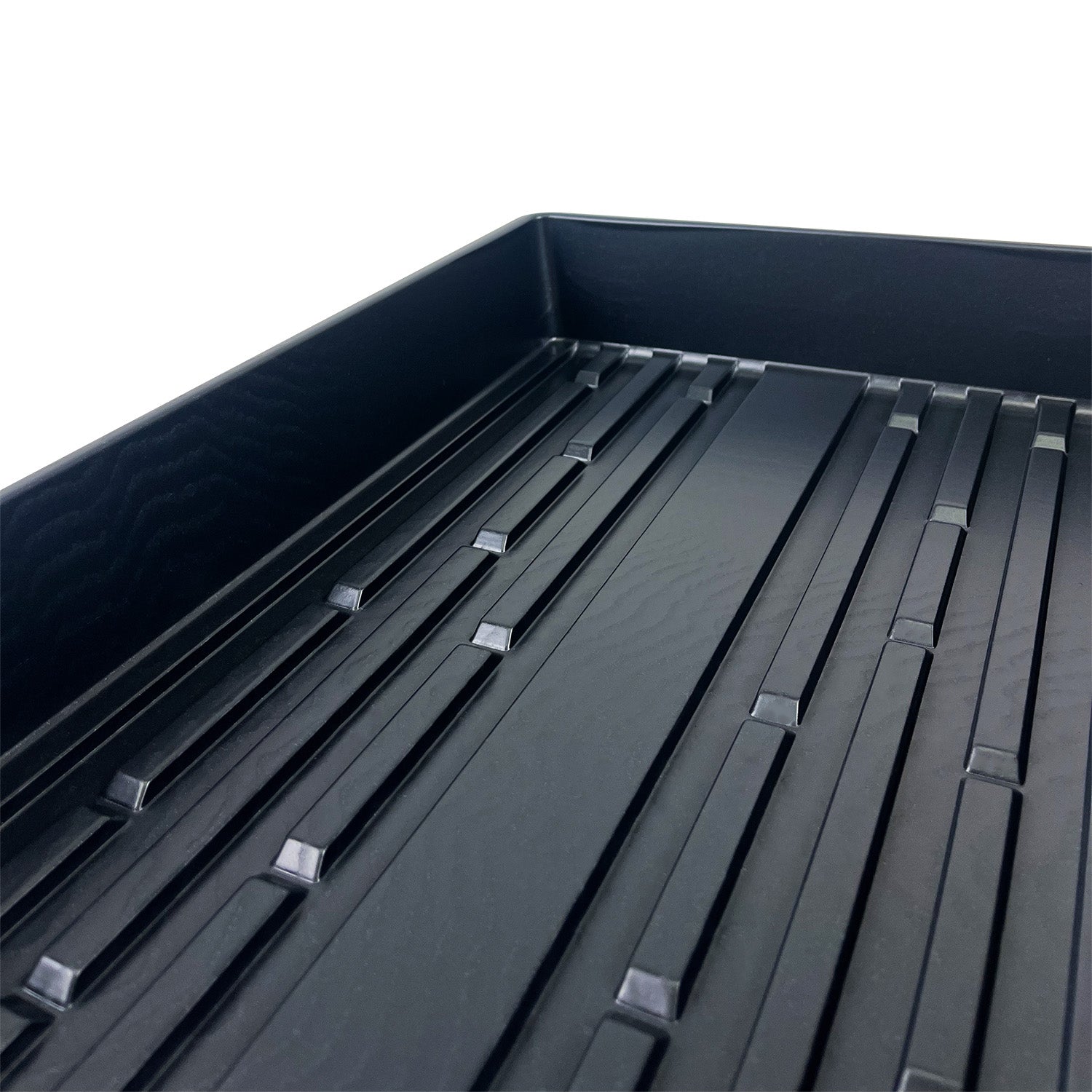 Close-up of a 20" x 10" Grow Tray without Holes (case of 10), showing its black plastic construction with raised rectangular ridges and a textured surface, photographed against a white background.